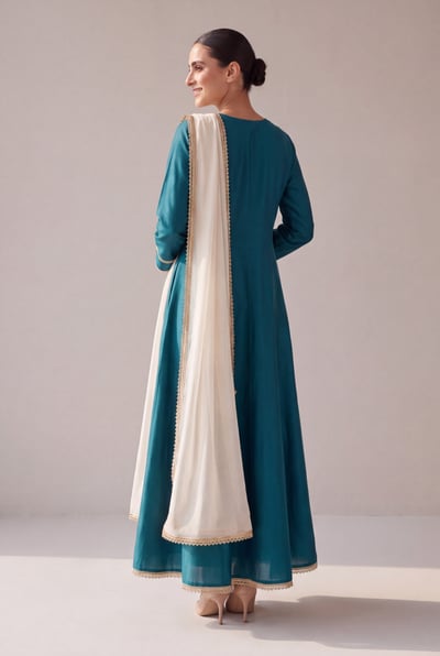Nain in teal silk, back view showing back kalidar flare and dupatta drape